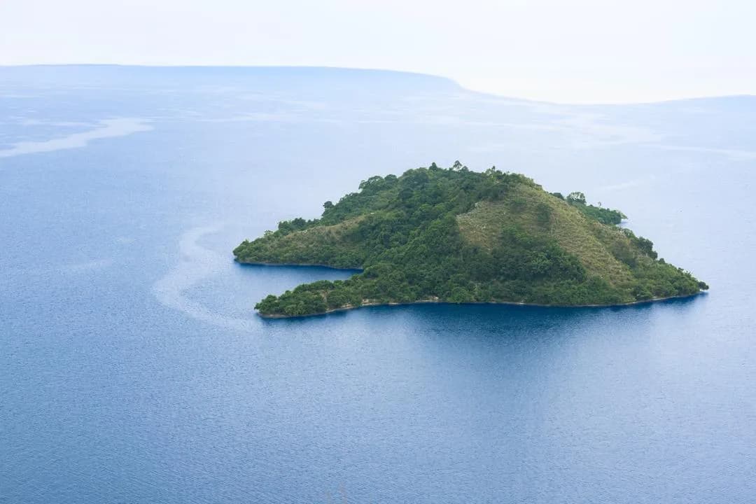 An island surrounded by the calm waters of Lake Kivu